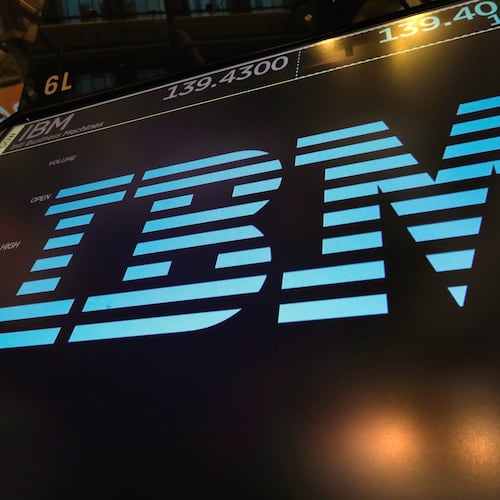 FILE - The logo for IBM appears above a trading post on the floor of the New York Stock Exchange, March 18, 2019. (AP Photo/Richard Drew, File)