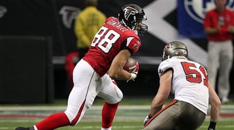 Falcons tight end Tony Gonzalez makes a reception and turns up field for yardage past Buccaneers linebacker Barrett Ruud.