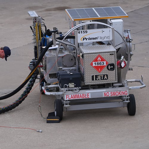 FILE - A worker finishes up fueling a jet at DFW International Airport in Grapevine, Texas, April 14, 2026. (AP Photo/LM Otero, File)