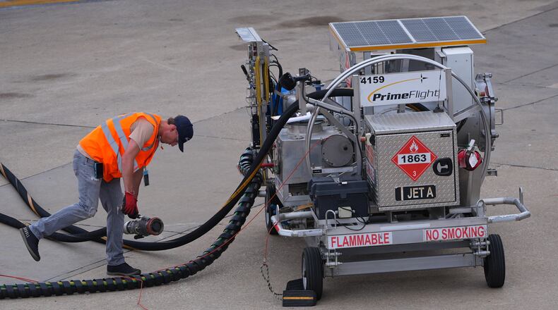 FILE - A worker finishes up fueling a jet at DFW International Airport in Grapevine, Texas, April 14, 2026. (AP Photo/LM Otero, File)