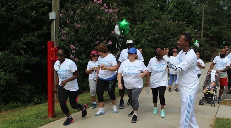 Stockbridge City Councilman Elton Alexander cheers on participants at "Trails Alive."