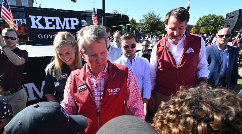 Georgia Gov. Brian Kemp, left, and Virginia Gov. Glenn Youngkin campaign together Tuesday in Alpharetta, one of Kemp's first visits this election cycle in the suburbs. (Hyosub Shin / Hyosub.Shin@ajc.com)