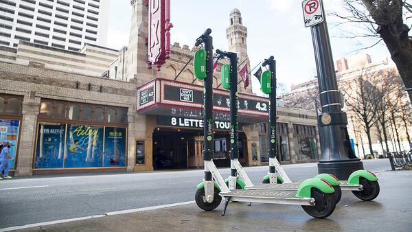 Lime Scooters are parked on the sidewalk across the street from the Fox Theater in Midtown. (Alyssa Pointer/AJC 2019)