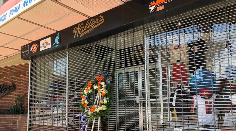 Walter Strauss, founder of Walter’s Clothing, a downtown institution, died at 94. A wreath is placed outside the store.