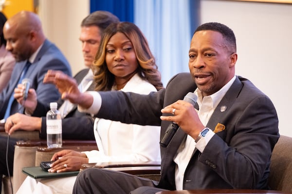 Derrick Jackson answers a question during a forum for Democratic candidates for governor at Morehouse College in Atlanta. The event was hosted by The Center for Strong Public Schools Action Fund. Co-founder and president Alisha Thomas Searcy is to the left.  (Ben Gray for the AJC)