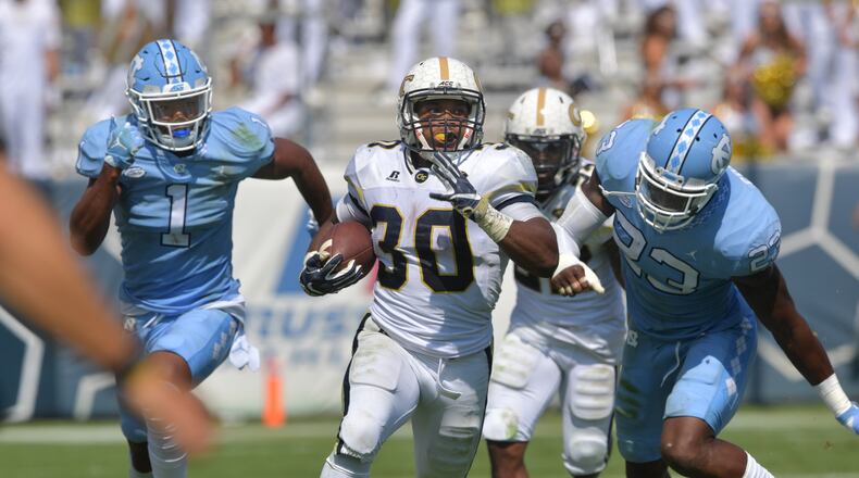 Georgia Tech running back KirVonte Benson breaks away for a 63-yard touchdown run in the third quarter against North Carolina. (HYOSUB SHIN / HSHIN@AJC.COM)