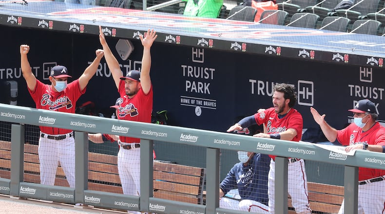 The Atlanta Braves dugout reacts as pinch hitter Pablo Sandoval hits a three RBI home run to take a 5-3 lead over the Miami Marlins during the sixth inning of a MLB baseball game on Thursday, April 15, 2021, in Atlanta.   “Curtis Compton / Curtis.Compton@ajc.com”
