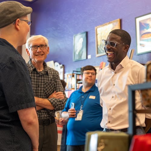 David Crowley, right, Democratic candidate for Wisconsin governor talks with CJ Arthur, left, owner of WordHaven BookHouse during a campaign stop with Wisconsin Gov. Tony Ever, center, Friday, Aug. 7, 2026, in Sheboygan, Wis. (AP Photo/Kayla Wolf)