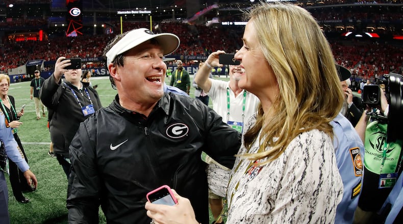 Georgia head football coach Kirby Smart celebrates winning the SEC Championship with his wife, Mary Beth, at Mercedes-Benz Stadium Dec. 2, 2017, in Atlanta.