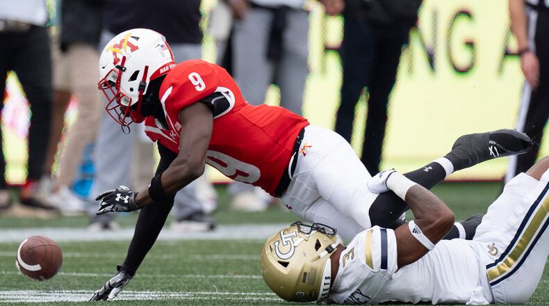 Virginia Military Institute wide receiver Julio DaSilva (9) fumbles after being hit by Georgia Tech defensive back Ahmari Harvey (3) during the first half of a NCAA college football game Sunday, Sept. 14, 2024, in Atlanta,. (AP Photo/John Bazemore)