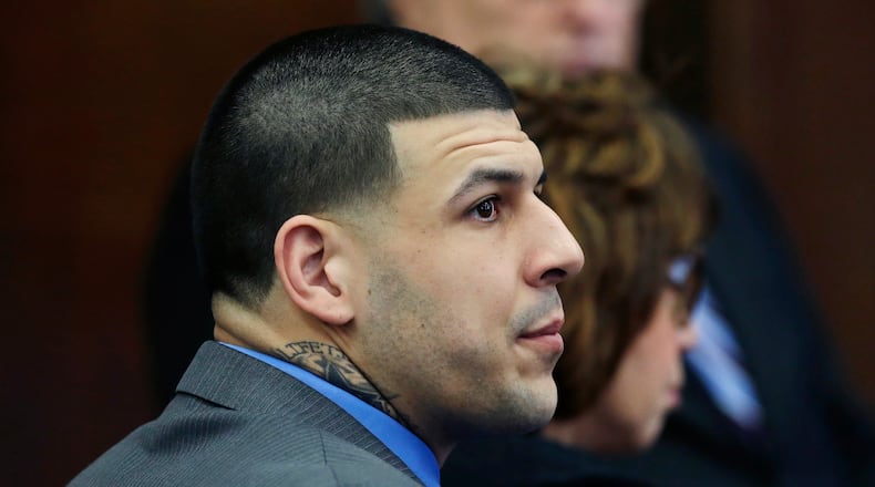 Defendant Aaron Hernandez listens as Judge Jeffrey Locke addresses the jury's question during his double murder trial at Suffolk Superior Court, Tuesday, April 11, 2017, in Boston. Hernandez is on trial for the July 2012 killings of Daniel de Abreu and Safiro Furtado who he encountered in a Boston nightclub. The former New England Patriots NFL player is already serving a life sentence in the 2013 killing of semi-professional football player Odin Lloyd. (AP Photo/Elise Amendola, Pool)