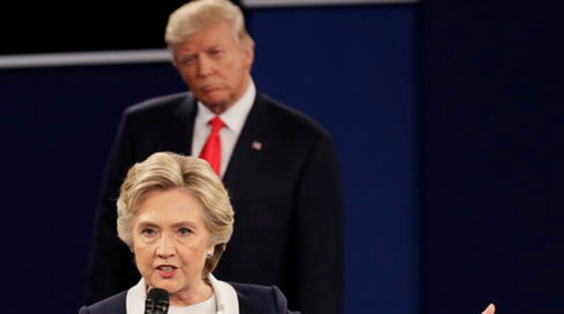Republican presidential nominee Donald Trump listens to Democratic presidential nominee Hillary Clinton during the second presidential debate at Washington University in St. Louis, Sunday, Oct. 9, 2016. (AP Photo/John Locher)