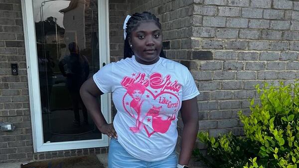 Tianah Robinson, 16, poses on white T-shirt with pink heart graphic.