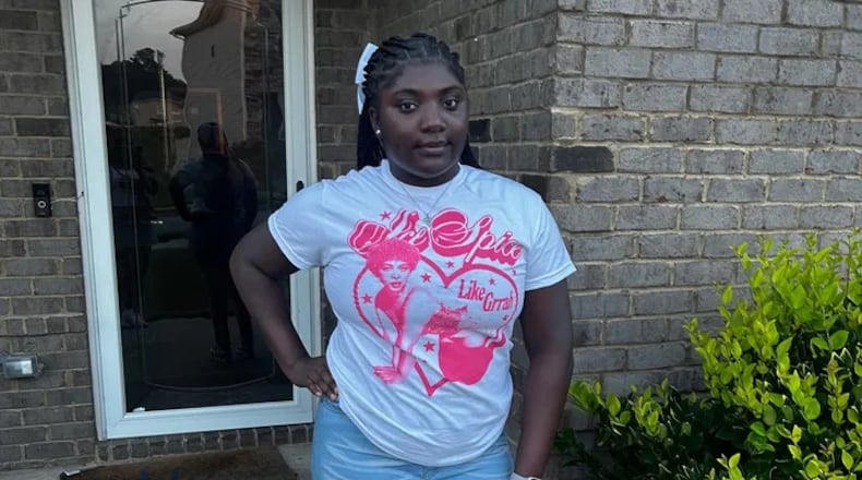Tianah Robinson, 16, poses on white T-shirt with pink heart graphic.
