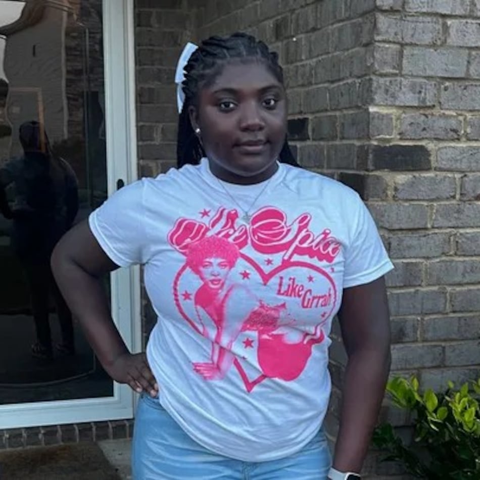 Tianah Robinson, 16, poses on white T-shirt with pink heart graphic.
