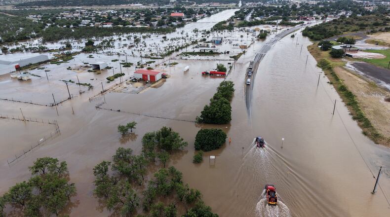 An aerial views shows flooding on Friday, July 17, 2026, in Ozona, Texas. (AP Photo/Gerald Herbert)