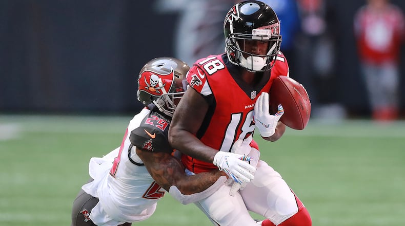 Tampa Bay Buccaneers Ryan Smith challenges Atlanta Falcons wide receiver Calvin Ridley on a reception Sunday, Oct. 14, 2018, in Atlanta.