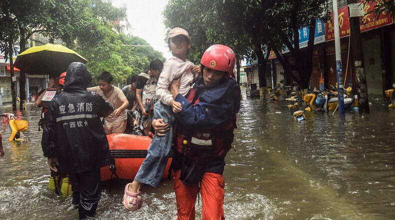 In this photo released by Xinhua News Agency, rescuers evacuate stranded residents in the aftermath of tropical storm Maysak in Qinzhou City, south China's Guangxi Zhuang Autonomous Region Tuesday, July 7, 2026. (Zhang Ailin/Xinhua via AP)