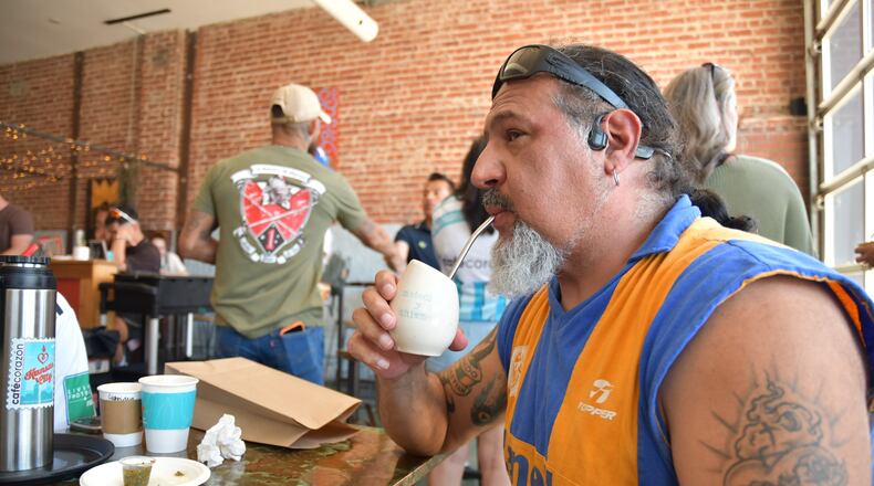 Rene Cufre, of Albuquerque, N.M., sips yerba mate at Cafe Corazon, Monday, June 15, 2026, in Kansas City, Mo. (AP Photo/Kristin M. Hall)