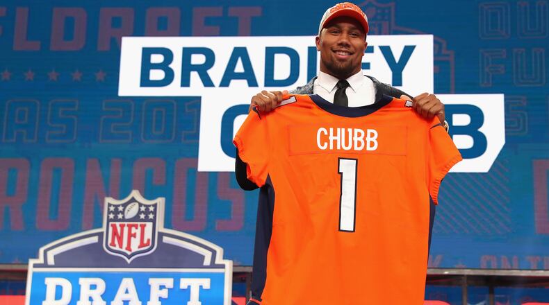 Marietta's Bradley Chubb poses with a Broncos jersey after being selected 5th overall by Denver in the 2018 NFL Draft Thursday, April 26, 2018, at AT&T Stadium in Arlington, Texas.
