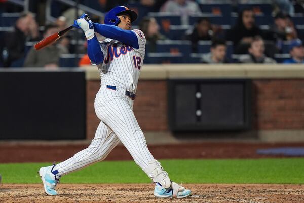 New York Mets' Francisco Lindor (12) follows through on a three-run home run during the seventh inningof a baseball game against the Philadelphia Phillies Monday, April 21, 2025, in New York. (AP Photo/Frank Franklin II)