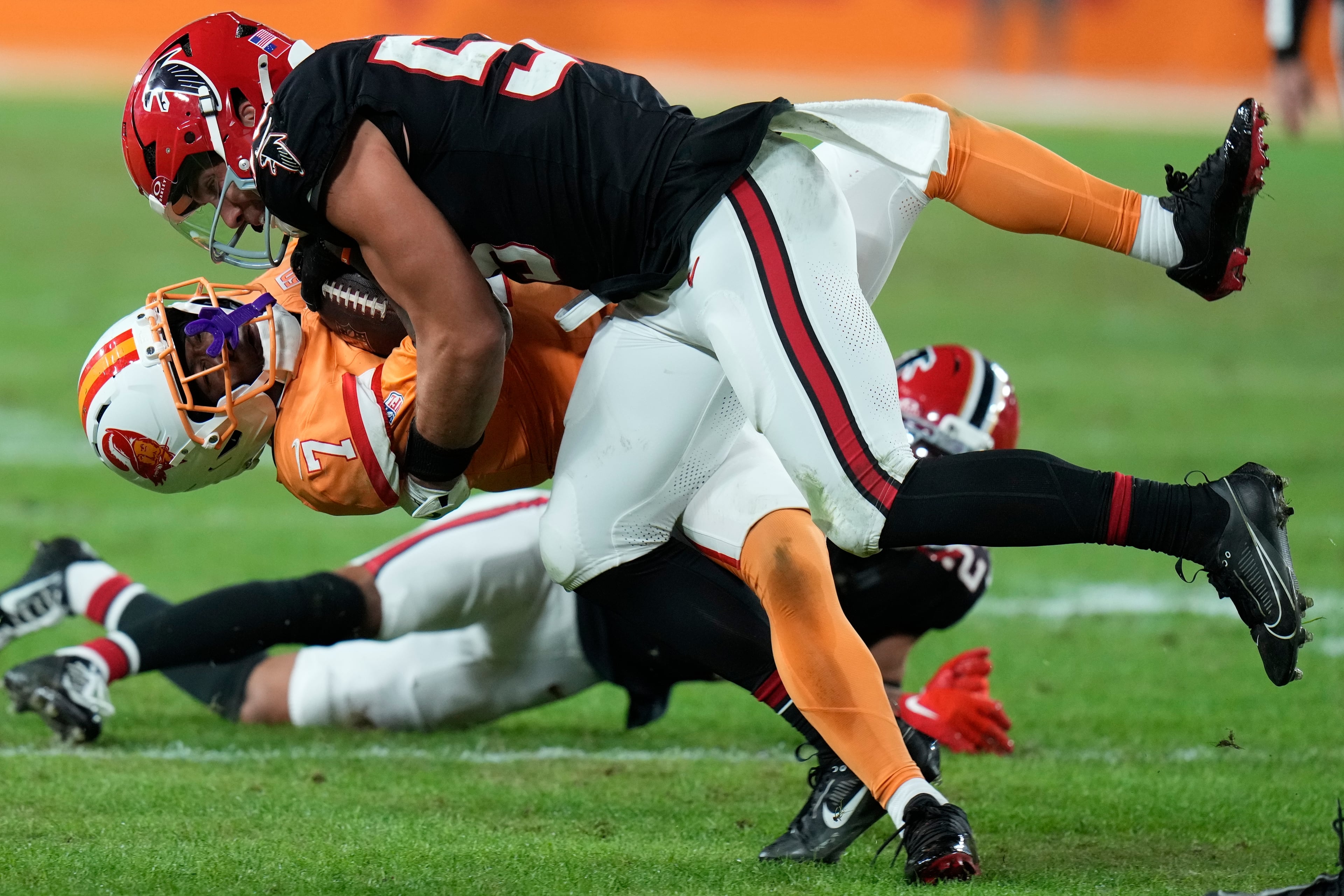 Atlanta Falcons linebacker Kaden Elliss (55) hits Tampa Bay Buccaneers running back Bucky Irving (7) during the first half of an NFL football game, Thursday, Dec. 11, 2025, in Tampa, Fla. (AP Photo/Chris O'Meara)