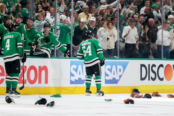 Dallas Stars center Mikael Granlund (64) celebrates with the Stars bench after earning a hat trick in the third period of Game 4 of a second-round NHL hockey playoff series in Dallas, Tuesday, May 13, 2025. (AP Photo/Gareth Patterson)