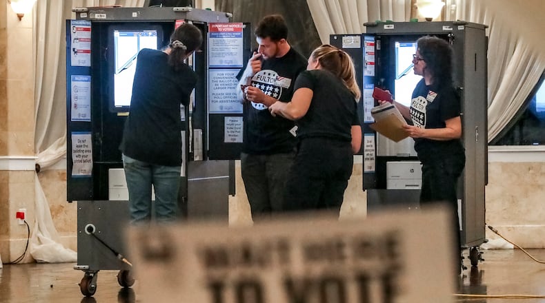 Poll workers prepare for voters In November 2022 at the Park Tavern in Atlanta. (John Spink / John.Spink@ajc.com)