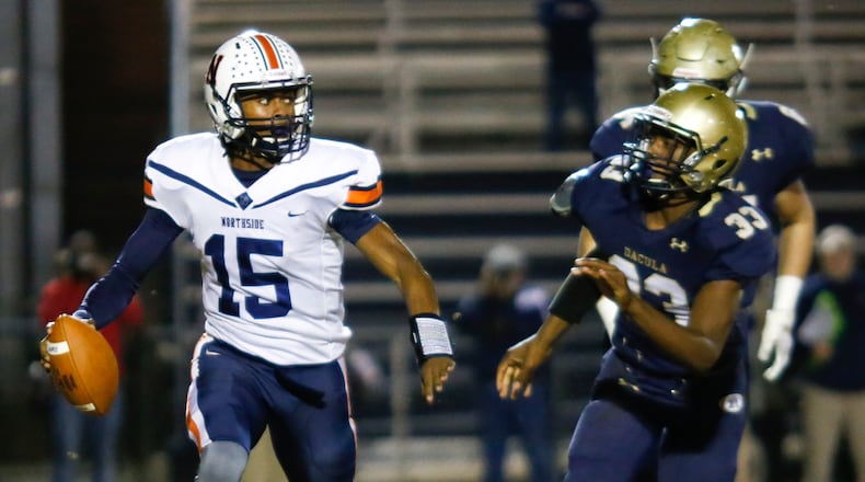 Northside Warner Robins quarterback Jadin Daniels (15) looks for a receiver under pressure from Dacula defenders during their 2018 Class AAAAAA semifinal in Dacula. (Casey Sykes/Special)