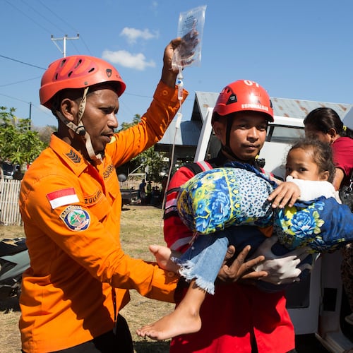 Rescuers carry a young earthquake survivor into an ambulance in North Lamba Leda, East Nusa Tenggara province, Indonesia, Tuesday, Aug. 18, 2026. (AP Photo/Firdia Lisnawati)