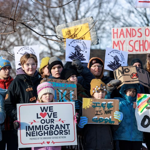 Minneapolis Public Schools families, educators and students hold signs during a news conference at Lake Hiawatha Park in Minneapolis, on Friday, Jan. 9, 2026, demanding Immigration and Customs Enforcement be kept out of schools and Minnesota following the killing of 37-year-old mother Renee Good by federal agents earlier on Wednesday. (Kerem Yücel/Minnesota Public Radio via AP)