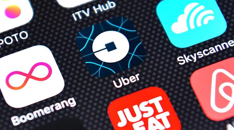 The Uber app logo is displayed on an iPhone. The ride-sharing service is exploring a new app feature that would allow a driver to tell if a potential rider is drunk.