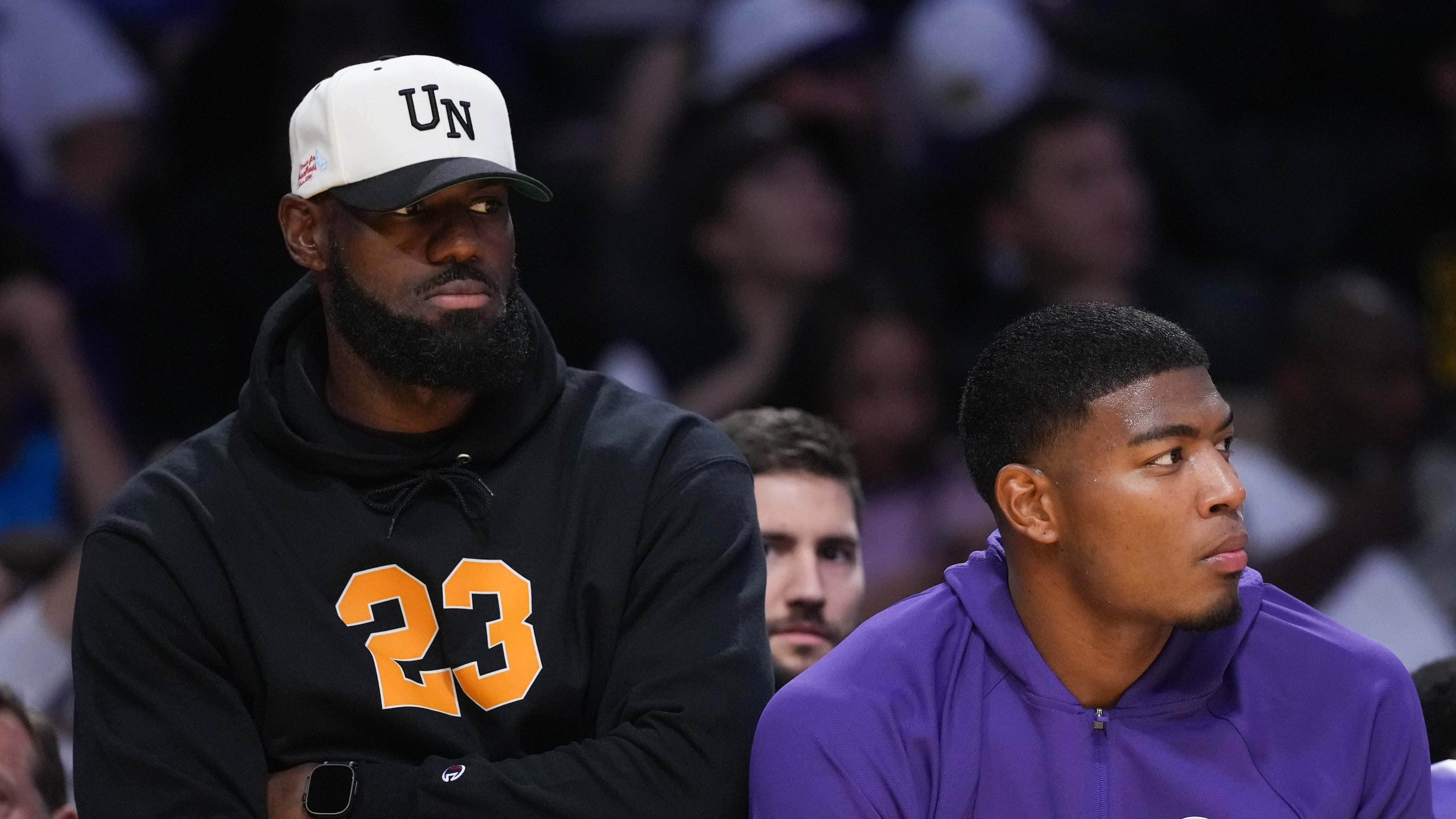 Los Angeles Lakers' Lebron James, left, and Rui Hachimura watch action from the bench during the first half of a preseason NBA basketball game against the Golden State Warriors Sunday, Oct. 12, 2025, in Los Angeles. (AP Photo/Jae C. Hong)