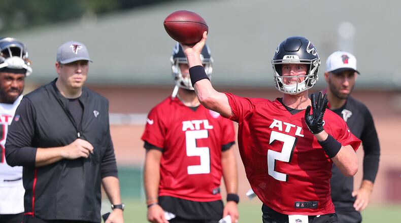 Falcons coach Arthur Smith (left) and offensive coordinator Dave Ragone (far right) look on as Matt Ryan looks to pass against the defense on the third day of training camp practice on Saturday, July 31, 2021, in Flowery Branch, Georgia. (Curtis Compton/AJC file)