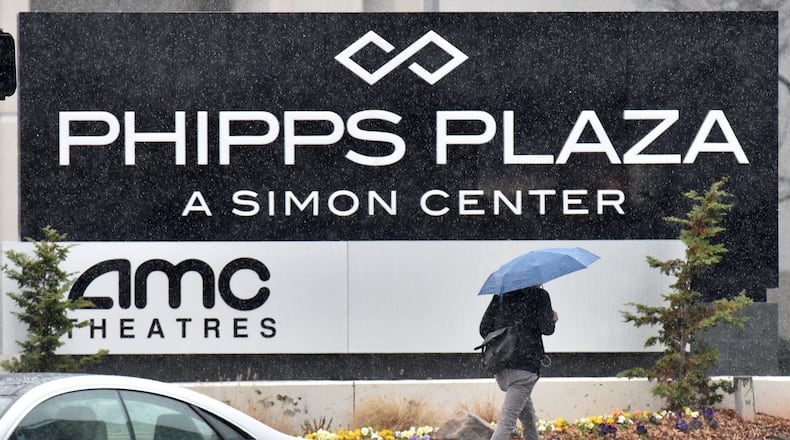 Jan. 6, 2017 Atlanta - A pedestrian with an umbrella makes her way near Phipps Plaza in Buckhead on Friday. The winter storm could bring 3 to 4 inches of snow accumulation in the county, officials said. HYOSUB SHIN / HSHIN@AJC.COM