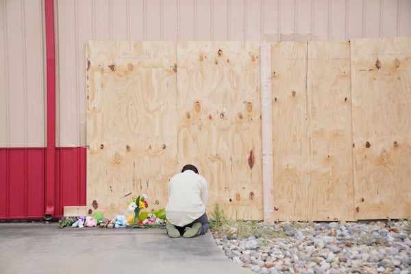 Harrison Allen, 14, kneels in prayer at the scene after a car barreled through a building used for an after-school camp Tuesday, April 29, 2025, in Chatham, Ill. (AP Photo/Erin Hooley)