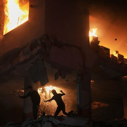 Palestinians react to a fire following an Israeli strike on a residential building in the Rimal neighborhood of Gaza City, Friday, May 15, 2026. (AP Photo/Jehad Alshrafi)