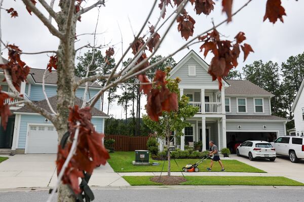 Paul Stelmaszyk mows his lawn at Heartwood in Richmond Hill, a 12,000-acre master planned community along I-95 south of Savannah. (Arvin Temkar/AJC)