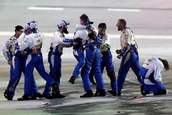 Crew members for driver Chase Elliott (9) celebrate after winning a NASCAR Cup Series auto race, Saturday, June 28, 2025, in Hampton, Ga. (AP Photo/Butch Dill)