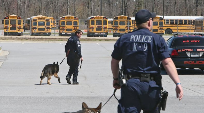 A Clayton County police K-9 unit sweep the local school district’s high schools on March 26, 2014. The Cherokee County School Board has decided to transfer its school police K-9 to the Cherokee County Sheriff’s Office. BOB ANDRES / AJC FILE