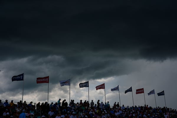 Storms clouds hang over the grandstand overlooking the eighth green during the third round of the U.S. Open golf tournament at Oakmont Country Club Saturday, June 14, 2025, in Oakmont, Pa. (AP Photo/Carolyn Kaster)