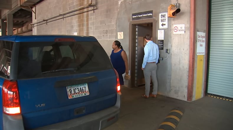 Former DeKalb County Commissioner Sharon Barnes Sutton leaves federal court in May, after being released from custody on a $25,000 unsecured bond. Sutton pleaded not guilty to federal charges that she took at least one bribe from a company trying to do business with the county and two counts of extortion. CREDIT: WSB-TV