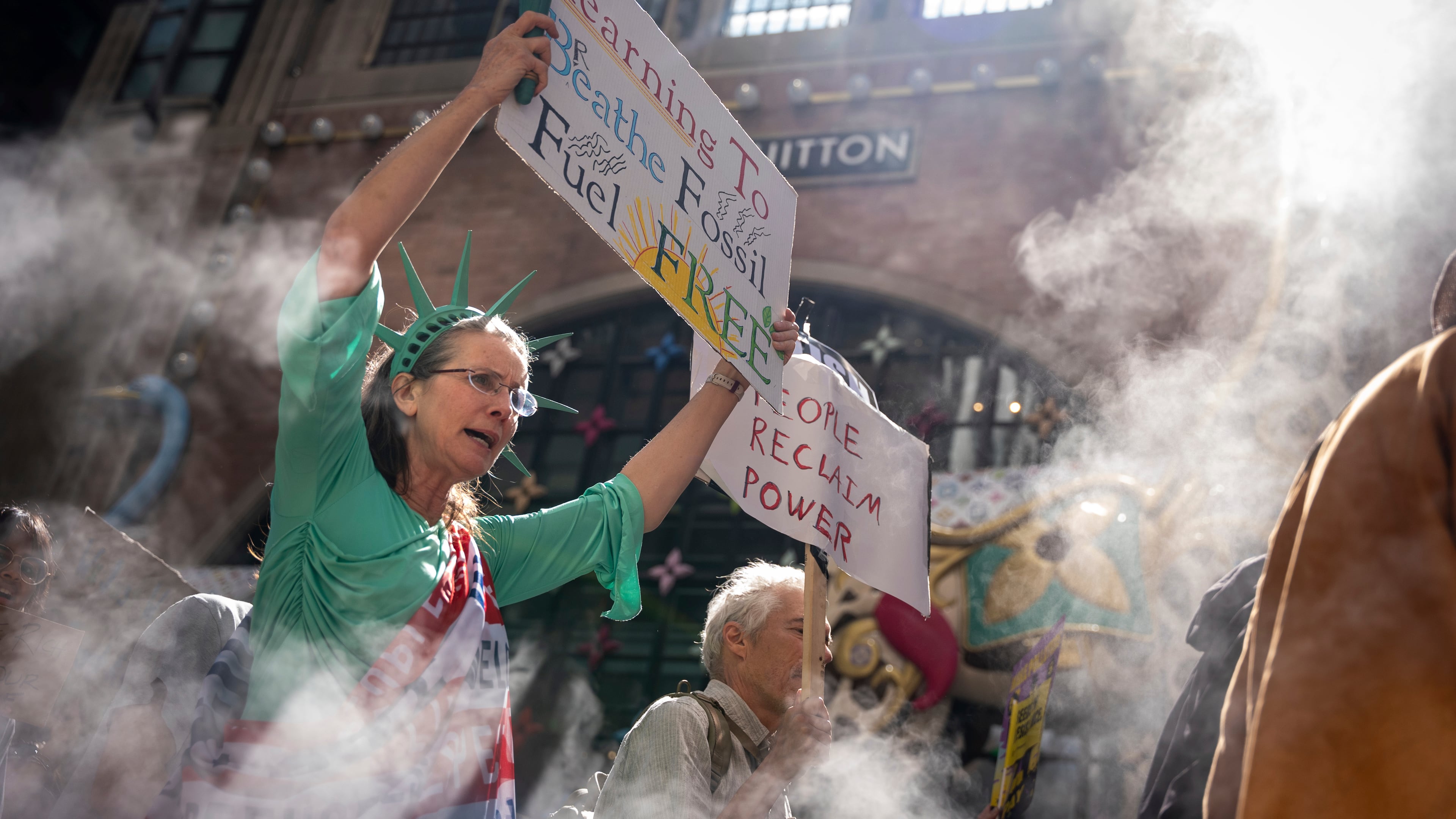 A woman dressed as the Statue of Liberty marches through Manhattan in the "Make Billionaires Pay" climate protest, Saturday, Sept. 20, 2025, in New York. (AP Photo/Angelina Katsanis)