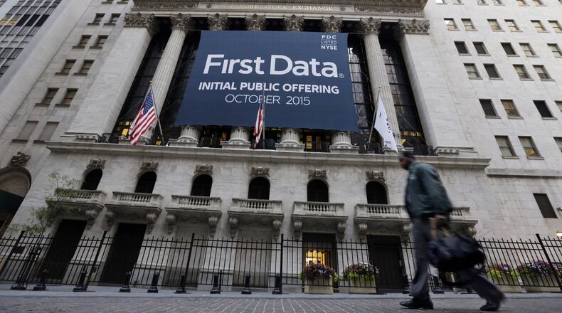 A banner for First Data Corp. adorns the facade of the New York Stock Exchange, to mark the company’s IPO, Thursday, Oct. 15, 2015. First Data is the leading payment services provider to the e-commerce industry, and will pay a $40 million fine after being caught up in a fraud investiation by the Federal Trade Commission. (AP Photo/Richard Drew)