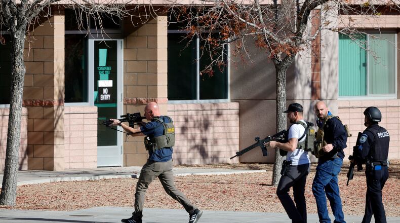 FILE - Law enforcement officers head into the University of Nevada, Las Vegas, campus after reports of an active shooter, Wednesday, Dec. 6, 2023, in Las Vegas. (Steve Marcus/Las Vegas Sun via AP, File)