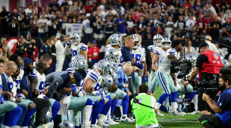 Jerry Jones and his Dallas Cowboys kneel on the field prior to the national anthem on Monday night.