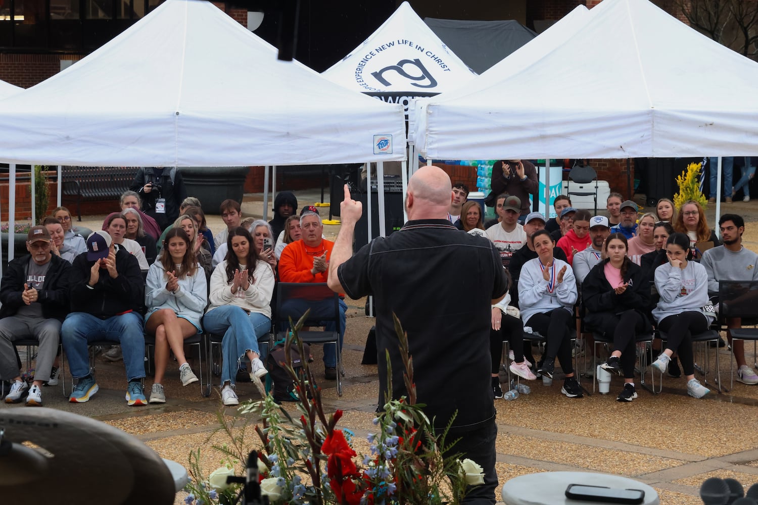 Derek Anglin, lead pastor of NewGrace Church in Commerce, Ga., speaks at UGA’s Tate Plaza on Saturday, Feb. 21, 2026, at a memorial service for Augusta University nursing student Laken Riley. Riley was attacked on Feb. 22, 2024 while running in Oconee Forest Park on the UGA campus and killed. Anglin’s sermon, “Run for Your Life,” inspired the memorial event’s title. (C.J. Bartunek for the AJC)
