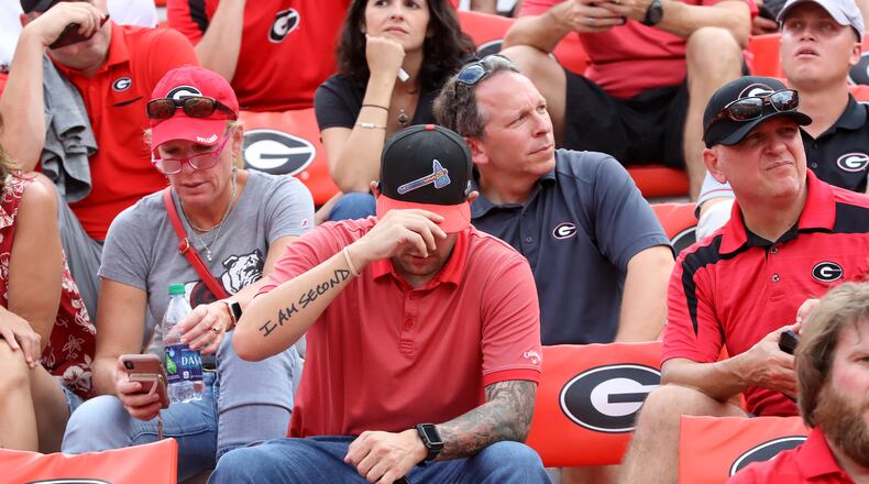 The portrait of the local fan: Three days after the Braves were ousted from the 2019 National League Division Series, this fellow in his tomahawk cap suffers a Georgia football loss to South Carolina. (Curtis Compton/ccompton@ajc.com)