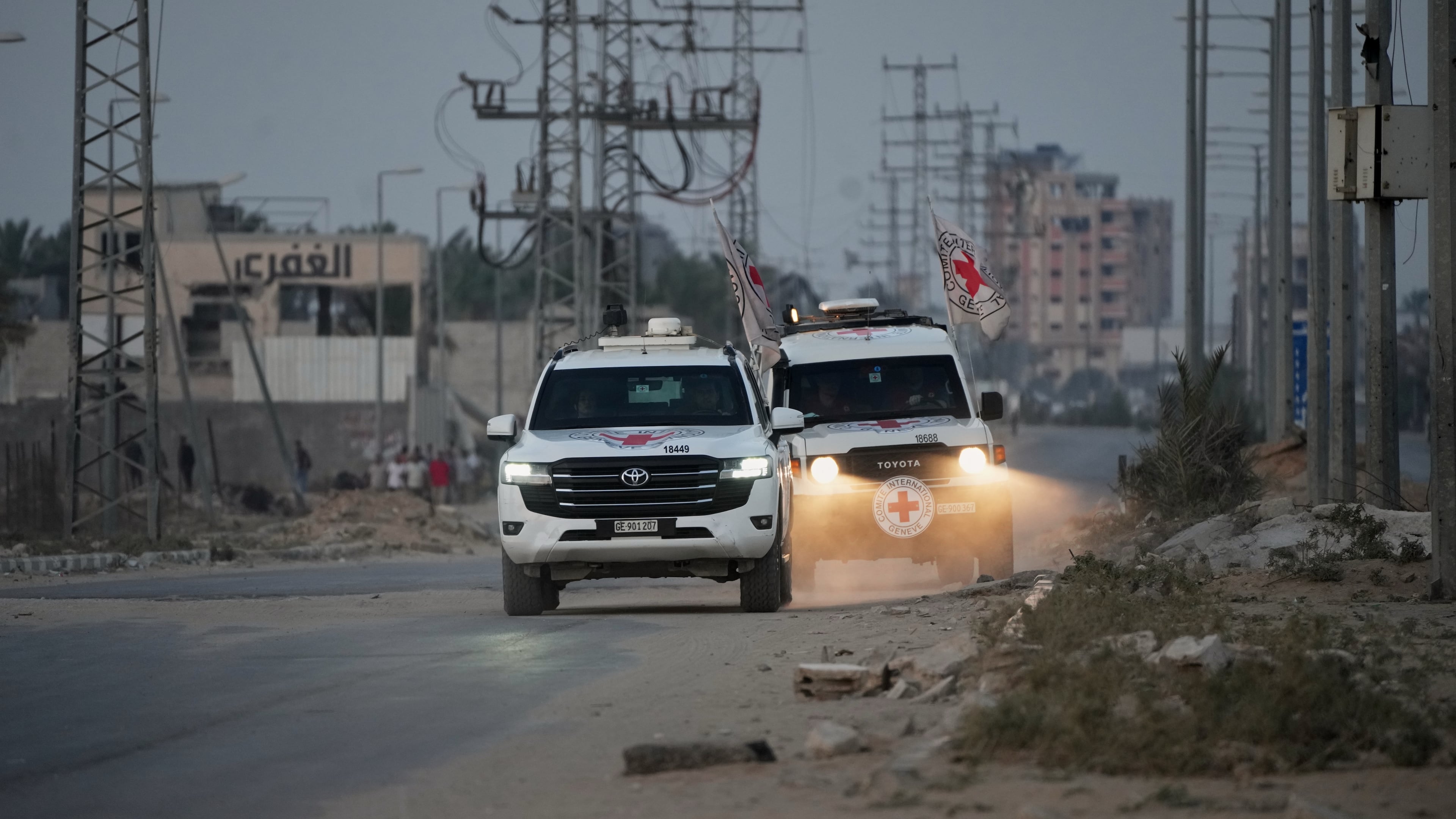 Red Cross vehicles carrying the bodies of two people believed to be deceased hostages handed over by Hamas make their way toward the Kissufim border crossing with Israel, to be transferred to Israeli authorities, in Deir al-Balah, central Gaza Strip, Thursday, Oct. 30, 2025. (AP Photo/Abdel Kareem Hana)