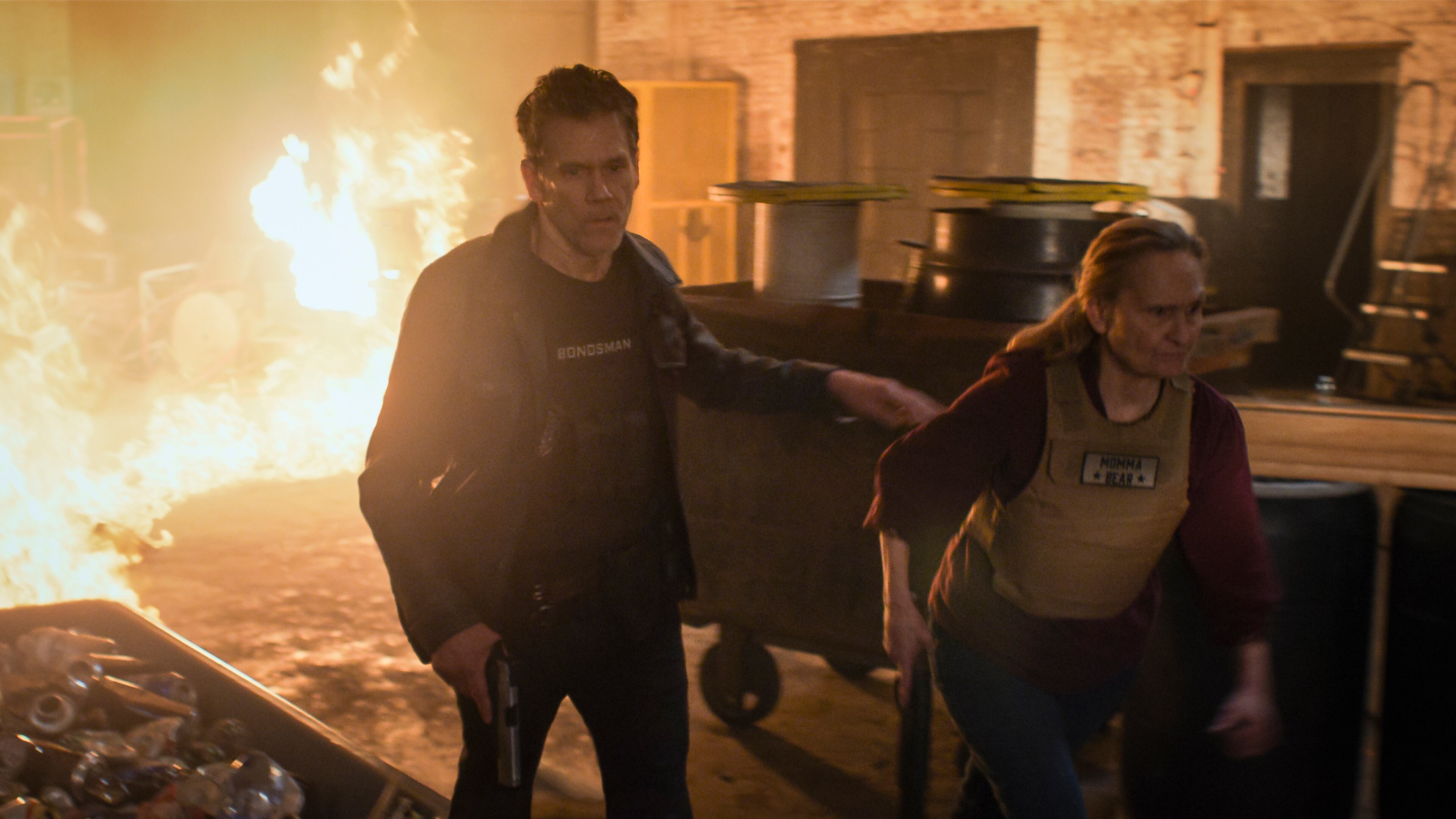 Kevin Bacon plays a bounty hunter who dies and comes back to take down demons in a new Amazon series "The Bondsman." His mom is played by Beth Grant (right). AMAZON